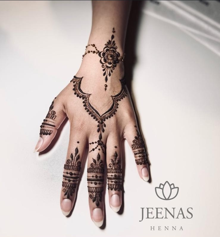 Floral trail henna design on one hand